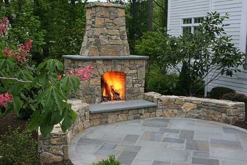 The outdoor patio fireplace designs featured here range from soaring hearths attached to the home